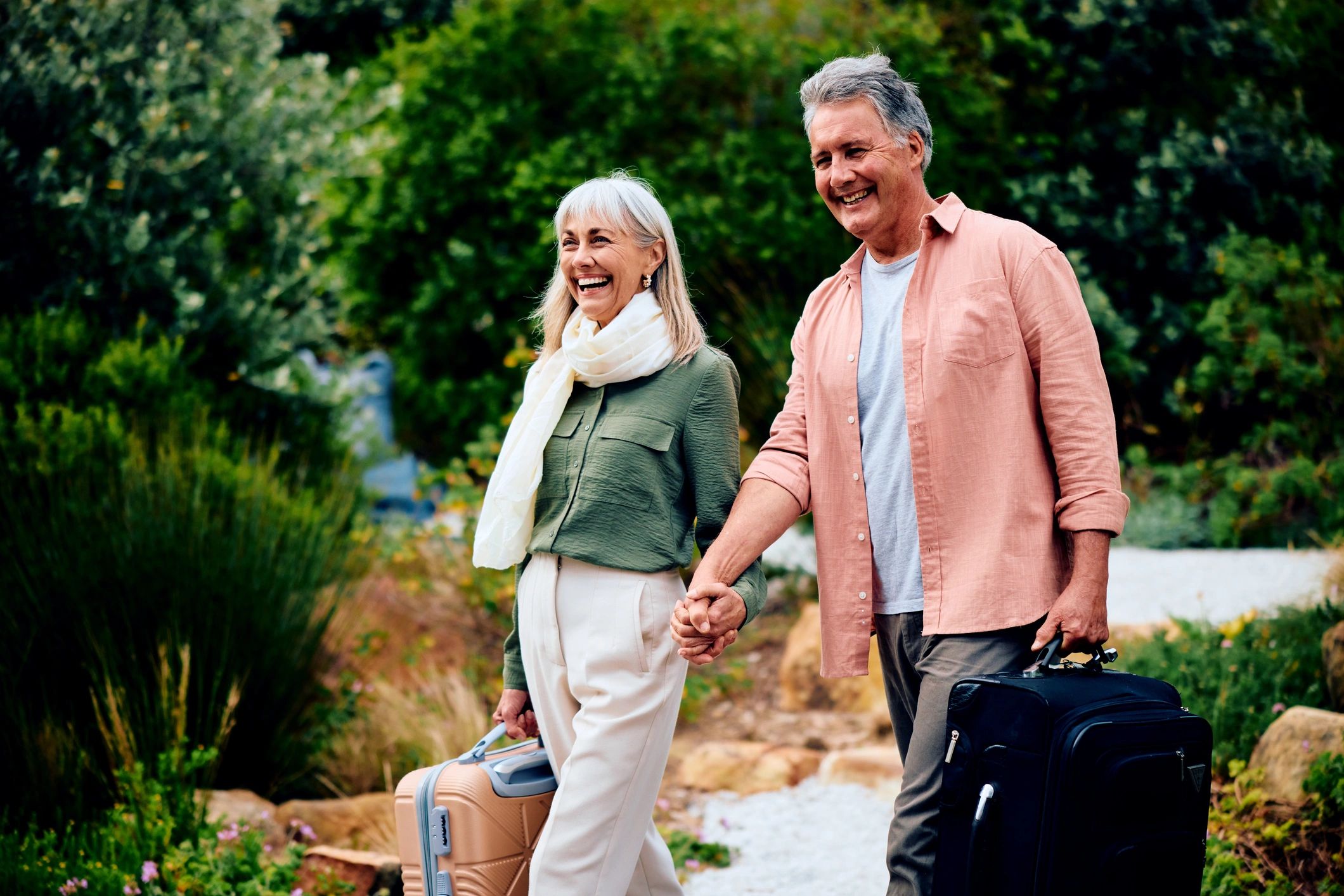 Senior couple arriving at a holiday destination with luggage