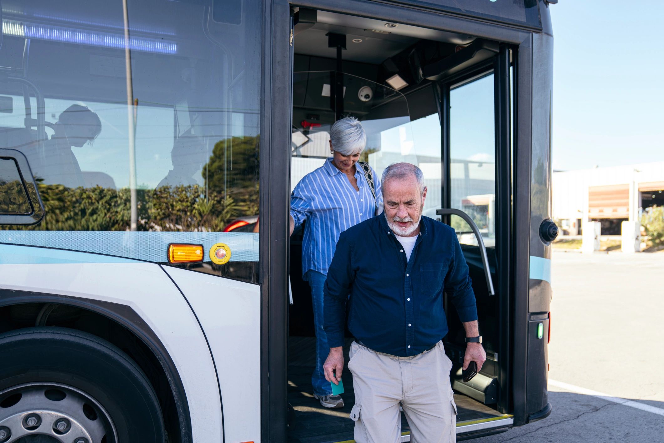 Senior couple using accessible public transport during travel
