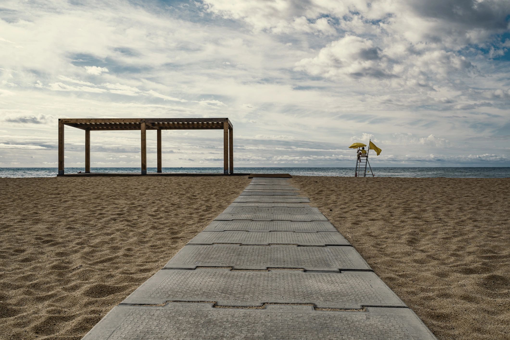 Quiet beach scene with promenade atmosphere